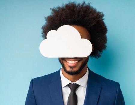 Portrait of a happy afro american businessman holding cloud on blue backgroundの素材