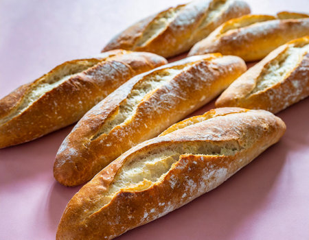 French baguettes on a pink background. Selective focus.の素材