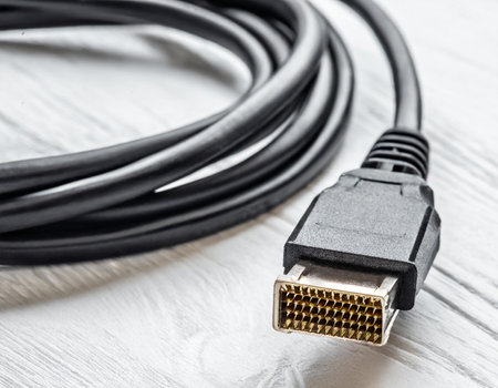 HDMI cable on white wooden background close up. Copy space.の素材