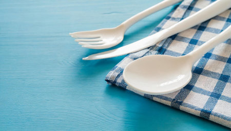 Table setting with tablecloth and cutlery on blue wooden backgroundの素材