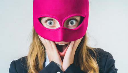 Surprised woman wearing a pink mask on a white background.の素材