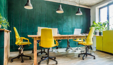 Interior of a modern office with yellow and green chairs and deskの素材