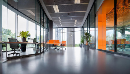 beautiful blurred background of a modern office interior in gray tones with panoramic windows glass partitions and orange color accentsの素材