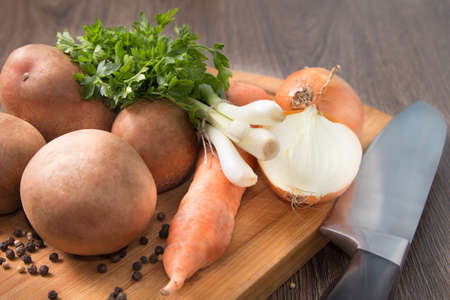 Natural organic vegetables on a chopping boardの写真素材