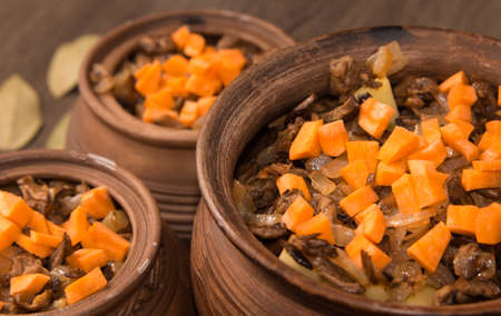 baked potatoes in a pot and oven with porcini mushroomsの写真素材