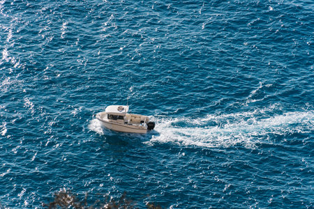 small boat pleasure sailing near the cliffsの写真素材