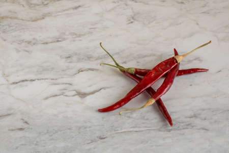 Chile de arbol, or dried chili peppers, on a marble bar with space for text