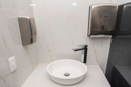 Sink with two dispensers, one for soap and the other for sanitary napkinsの写真素材