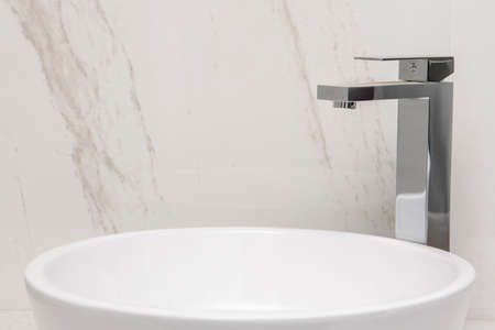 Sink with mixer on a marble base and wallsの写真素材