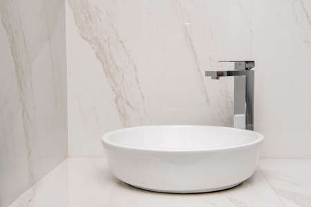 Sink with mixer on a marble base and wallsの写真素材