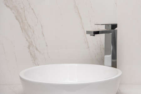 Sink with mixer on a marble base and wallsの写真素材