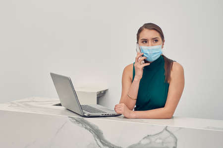 Executive woman, making call wearing mouth covers due to the new normal due to the covid-19 pandemicの写真素材