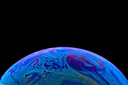 Soap bubble simulating the atmosphere of a planet with different shapes, colors and a black...
