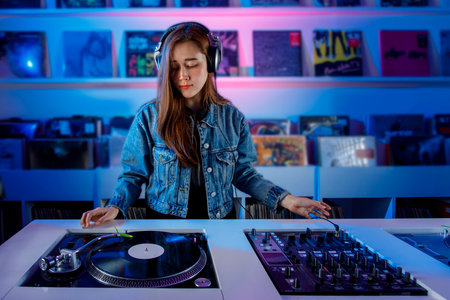 Young latin dj woman mixing music in a vinyl record store. Retro music concept with vinyl records