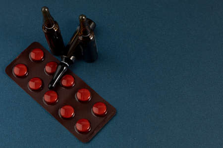 Group of drugs with pills and ampoules with a blue background and space for text
