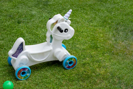 Mountable unicorn for childrens party in a garden with green grassの写真素材