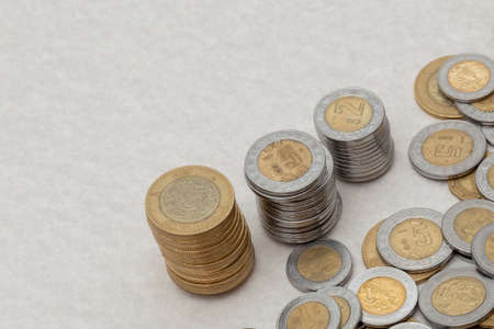stack of mexican peso coins of various denominations, with copy space.の写真素材