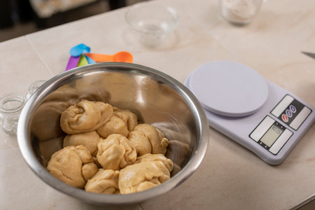Portions of dough to make bread of the dead, inside a bowl on a table