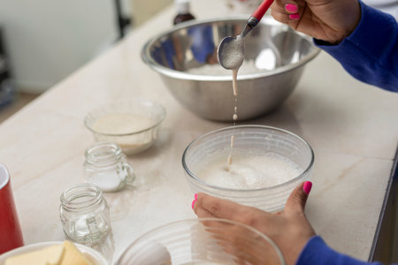 close up of womans hands mixing yeast to make bread