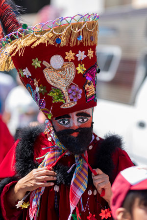 A chinelo with his sombrero looking at the camera while dancing in a carnival in Mexicoの写真素材