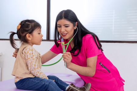 Pediatrician doing a breathing test to a little girl in her medical officeの写真素材