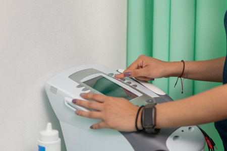 Electrotherapy and ultrasound equipment, for physical rehabilitation, being manipulated by the hand...