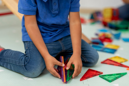 Hands of a child who is assembling a figure with educational piecesの写真素材