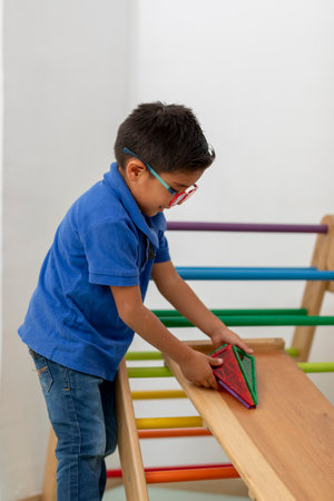 Boy rolling a toy car down a rampの写真素材