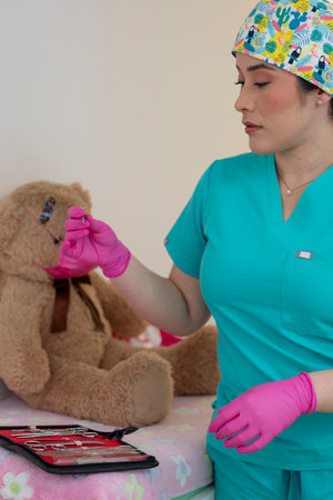 Veterinarian preparing syringe for teddy bear patientの写真素材