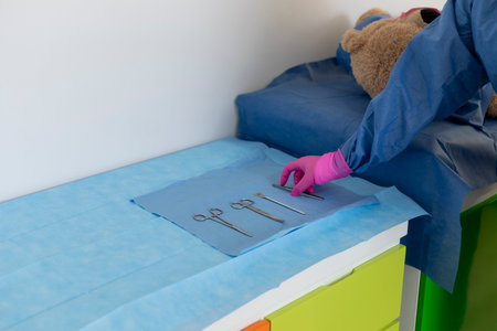 Veterinarian preparing surgical instruments for teddy bear operationの写真素材
