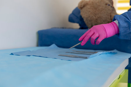 Veterinarian picking surgical forceps for operating teddy bear in veterinary clinicの写真素材