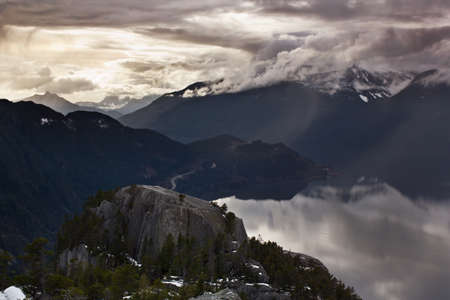 View of the mountain top with ocean and mountains in the backgroundの写真素材