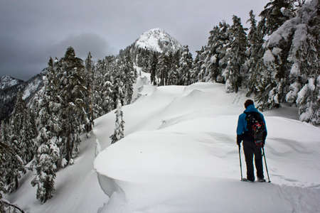 Hiker looking at the way up to the top of the mountainの写真素材