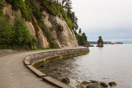Siwash Rock in Stanley Park on the Seawall. Taken in Downtown Vancouver, British Columbia, Canada, on a cloudy evening.の写真素材
