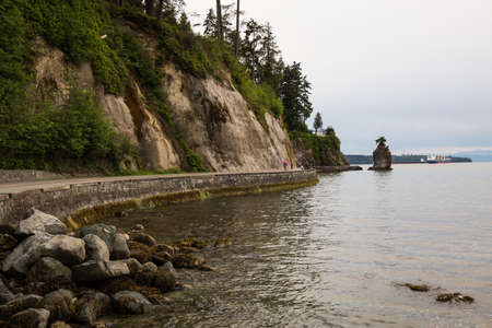 Siwash Rock in Stanley Park on the Seawall. Taken in Downtown Vancouver, British Columbia, Canada, on a cloudy evening.の写真素材