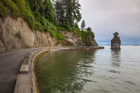 Siwash Rock in Stanley Park on the Seawall. Taken in Downtown Vancouver, British Columbia, Canada, on a cloudy evening.の写真素材