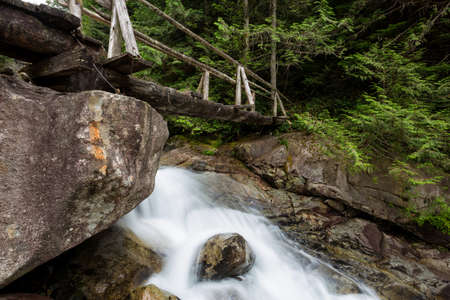 Wooden Bridge across a a running river. Taken while traveling to Widgeon Lake, British Columbia, Canada.の写真素材