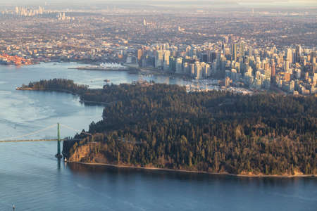 Stanley Park, Lions Gate Bridge and Downtown Vancouver from an Aerial Perspective. Picture taken in British Columbia, Canada, during a sunny evening.の写真素材