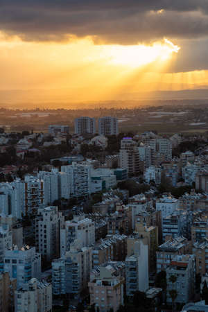 Aerial view of a residential neighborhood in a city during a cloudy sunrise. Taken in Netanya, Center District, Israel.の写真素材