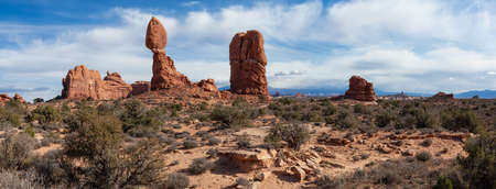 Panoramic Landscape view of beautiful red rock canyon formations during a vibrant sunny day. Taken in Arches National Park, located near Moab, Utah, United States.の写真素材