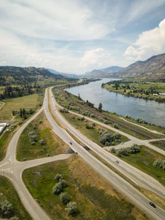 Aerial view of Trans-Canada Highway near Thompson River during a vibrant sunny summer day. Taken near Kamloops, BC, Canada.の写真素材
