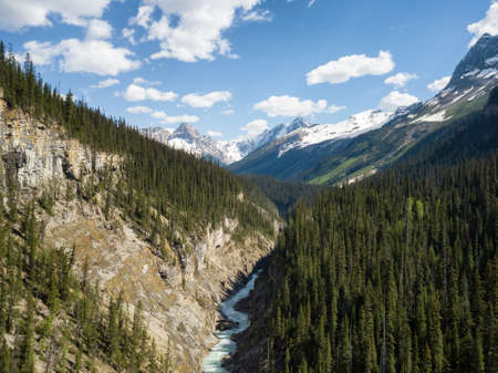 Aerial panoramic view of a beautiful canyon in the Canadian Rockies during a vibrant sunny day....