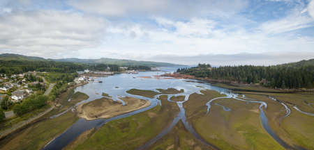 Aerial panoramic view of a small town, Port Hardy, during a cloudy summer day. Located in Northern...