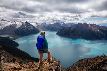 Adventurous girl enjoying the beautiful Canadian Mountain Landscape during a vibrant summer day. Taken in Garibaldi Provincial Park, located near Whister and Squamish, North of Vancouver, BC, Canada.の写真素材