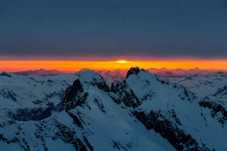 Beautiful aerial view of Canadian Mountain Landscape during a dramatic sunset. Taken near Squamish,...
