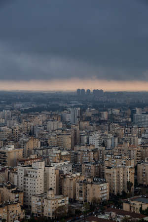 Aerial view of a residential neighborhood in a city during a cloudy sunrise. Taken in Netanya, Center District, Israel.の写真素材