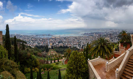 Beautiful panoramic view of Bahai Gardens and a city on the coast of Mediterranean Sea during a cloudy day. Taken in Haifa, Israel.の写真素材