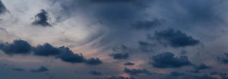 Dramatic cloudscape during a dark and colorful sunset.の写真素材