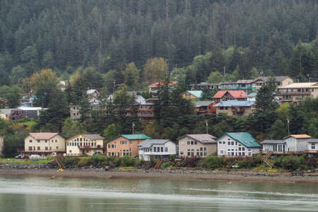 Beautiful view of a small town, Juneau, during a cloudy morning with mountains in the background. Taken in Alaska, United States.の写真素材