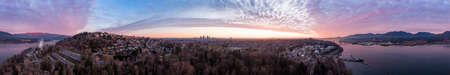 Aerial Panoramic View of a modern city during a colorful and cloudy sunset. Taken in Burnaby, Greater Vancouver, British Columbia, Canada.の写真素材